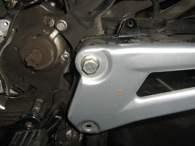 the swingarm and chain sit outside of the main motorcycle frame